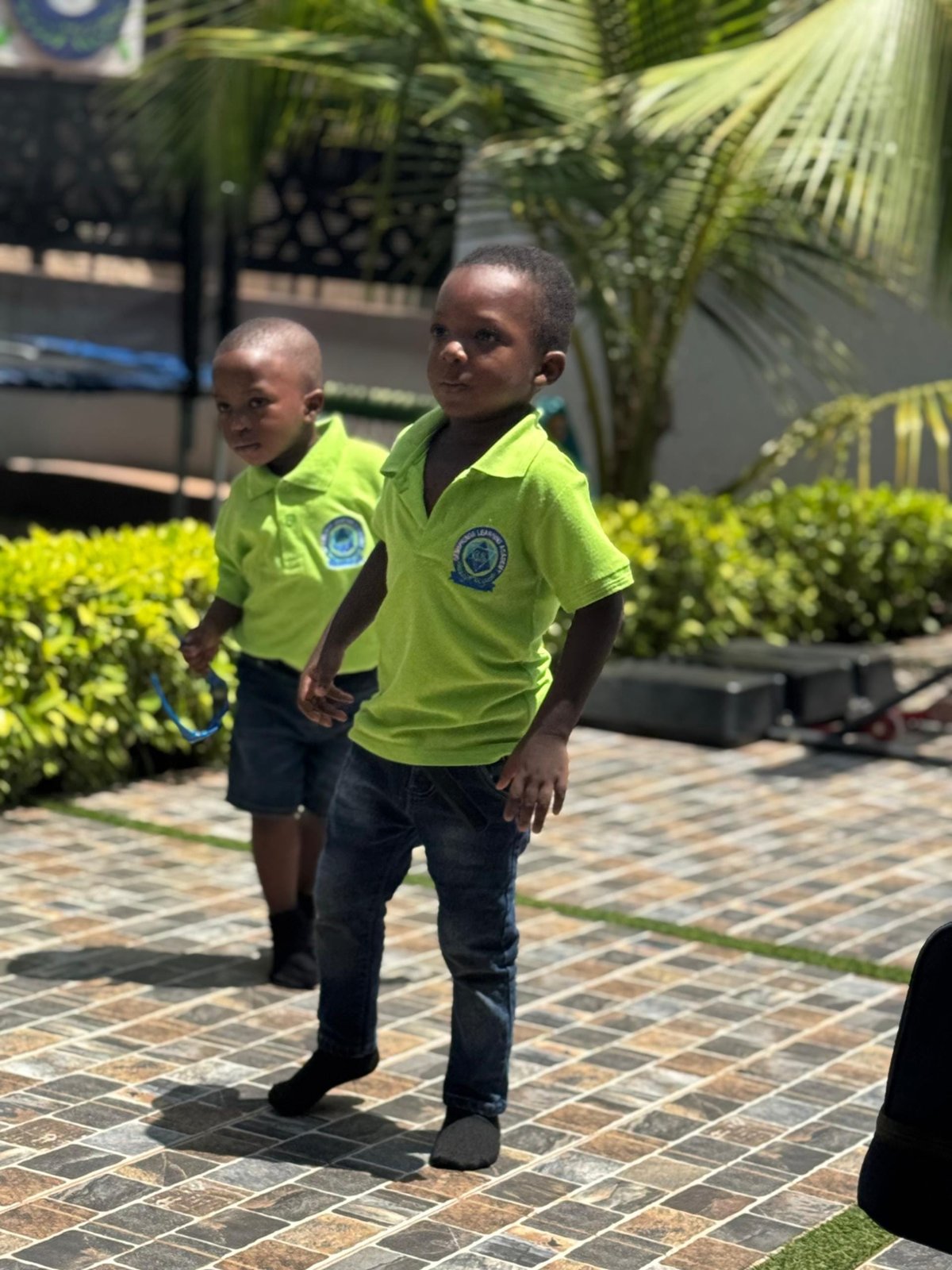 Two boys in school uniform walking outside